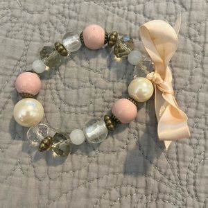 Elastic beaded bracelet with fabric bow